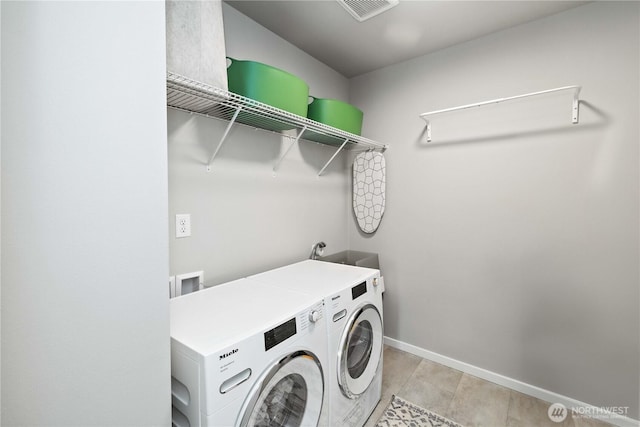 24014 Lily Pl SE, Black Diamond, WA 98010 - washroom with washing machine and clothes dryer and baseboards