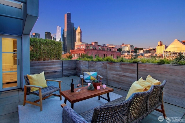 view of patio / terrace with an outdoor living space and a city view