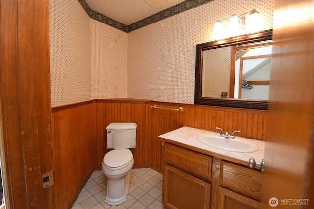 13029 322nd Ave NE, Duvall, WA 98019 - half bathroom featuring vanity, toilet, wooden walls, tile patterned floors, and a wainscoted wall