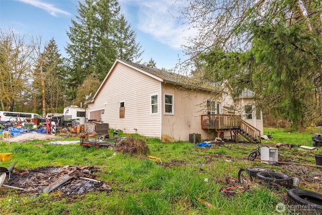 view of side of home featuring stairs and a wooden deck