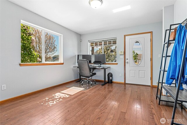 office area featuring healthy amount of natural light, hardwood / wood-style flooring, and baseboards