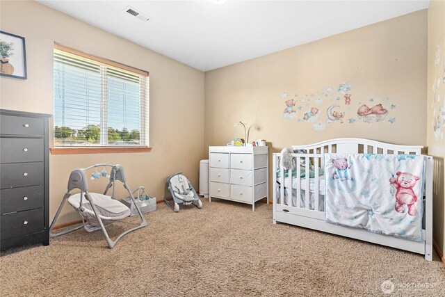 bedroom with carpet flooring, a nursery area, and baseboards