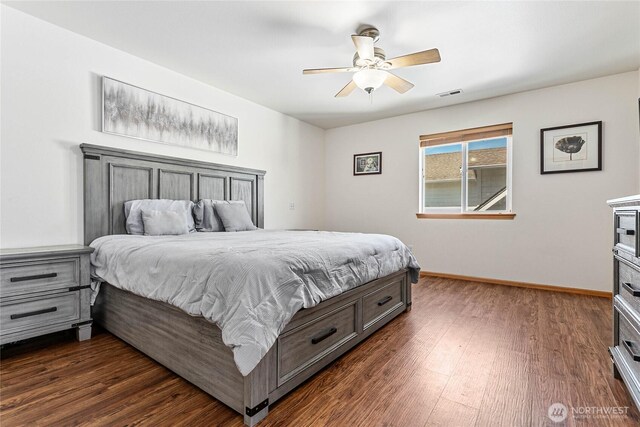 bedroom featuring dark wood-style floors, baseboards, and a ceiling fan