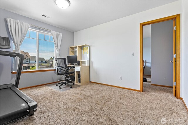 carpeted home office featuring baseboards
