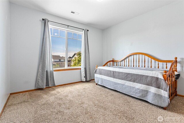 carpeted bedroom featuring baseboards
