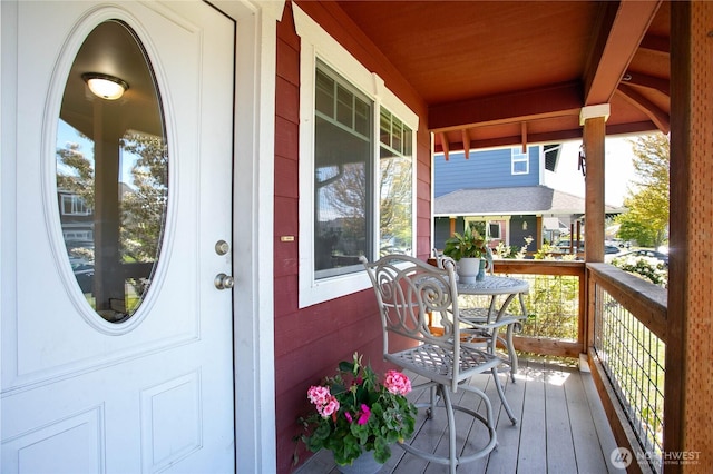 view of exterior entry featuring covered porch