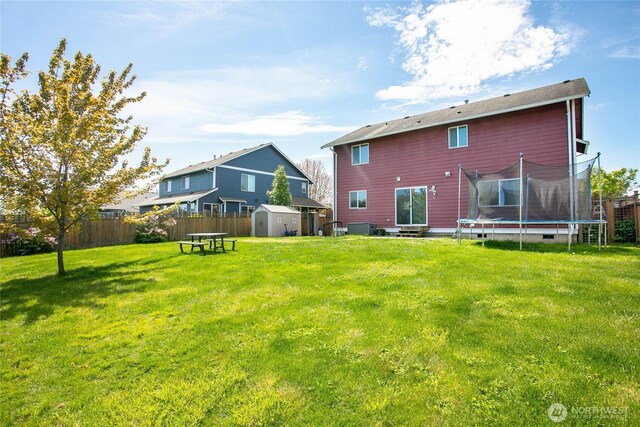 back of property with a trampoline, a storage unit, an outbuilding, and entry steps