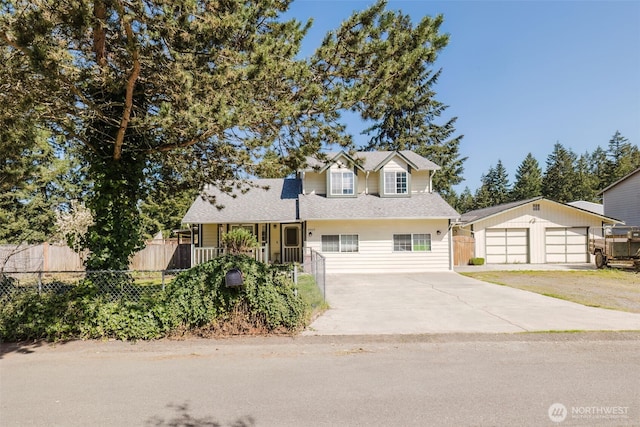 traditional home featuring fence, driveway, an outdoor structure, and a garage