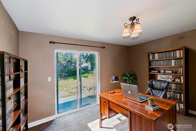 office with a chandelier, carpet floors, and baseboards