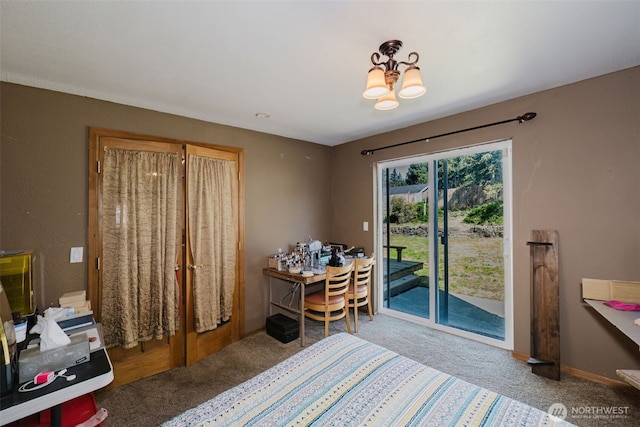 carpeted bedroom featuring a notable chandelier, baseboards, and access to outside