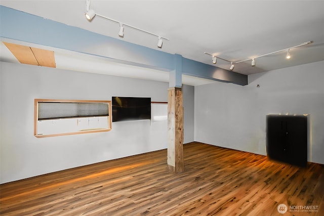 finished basement with track lighting and wood finished floors