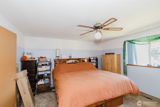 bedroom featuring visible vents, a ceiling fan, and light colored carpet
