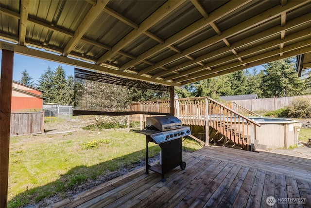 wooden deck featuring a fenced backyard, stairs, a lawn, and area for grilling
