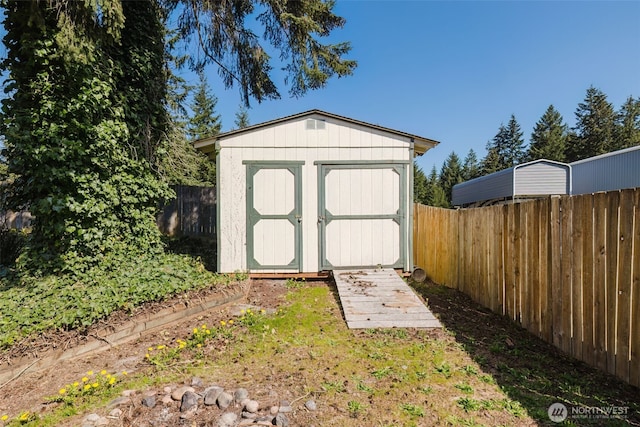 view of shed featuring a fenced backyard