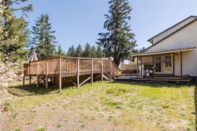 view of yard featuring french doors, stairway, and a deck