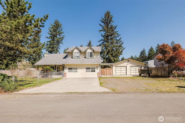 view of front of property featuring a shingled roof, concrete driveway, and fence