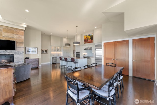 9535 Semiahmoo Pkwy Unit B305, Blaine, WA 98230 - dining space featuring a high ceiling, recessed lighting, a fireplace, and dark wood finished floors