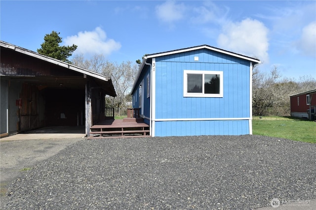 view of front facade featuring driveway and a wooden deck