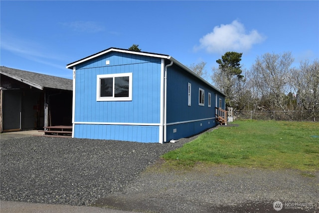 view of home's exterior featuring fence and a yard