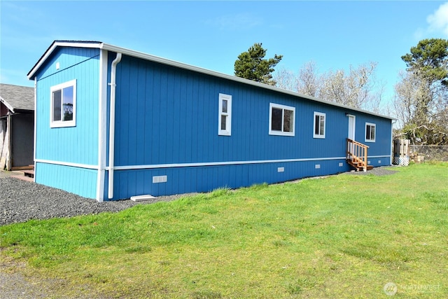 exterior space featuring a lawn and entry steps