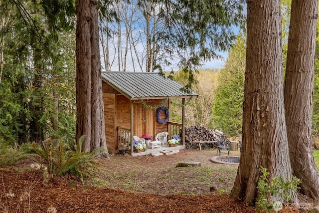 view of outdoor structure featuring an outdoor structure and a fire pit