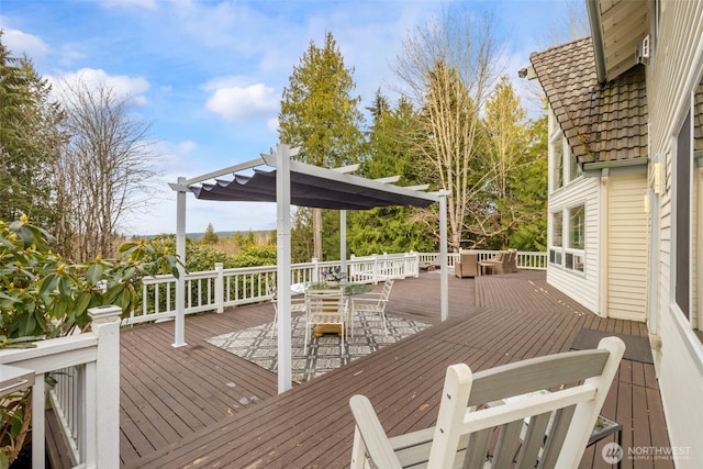 wooden terrace featuring a pergola and outdoor dining area