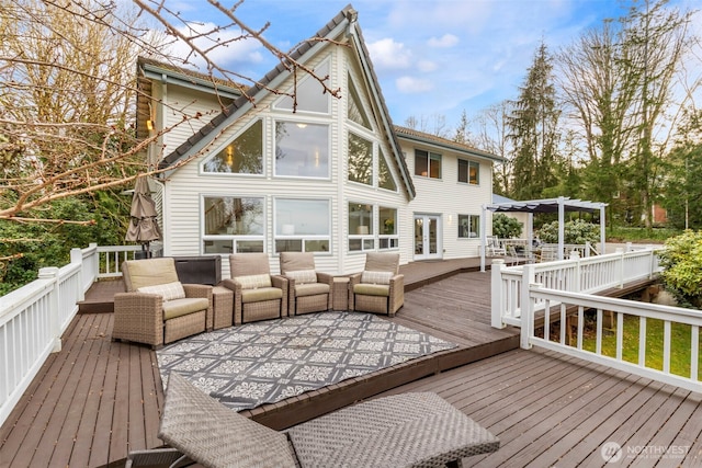 wooden terrace with a pergola, french doors, and an outdoor living space