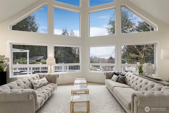 sunroom / solarium with high vaulted ceiling