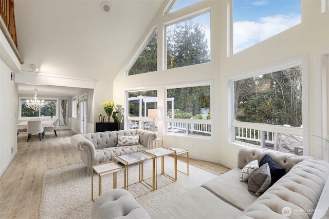sunroom / solarium featuring an inviting chandelier and a healthy amount of sunlight