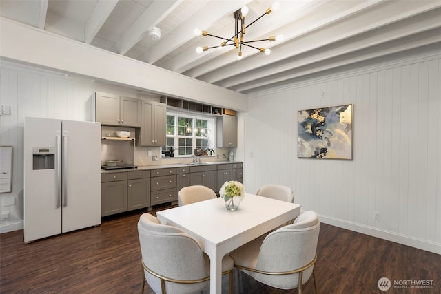 dining space featuring baseboards, beam ceiling, a chandelier, and dark wood-style flooring