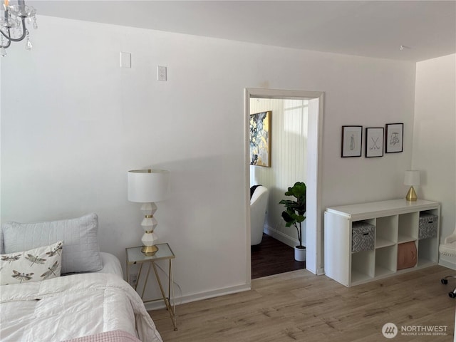bedroom with baseboards and wood finished floors