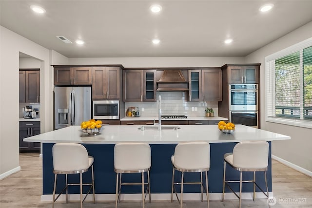 32904 SE Stevens St, Black Diamond, WA 98010 - kitchen with light countertops, visible vents, stainless steel appliances, a sink, and custom range hood