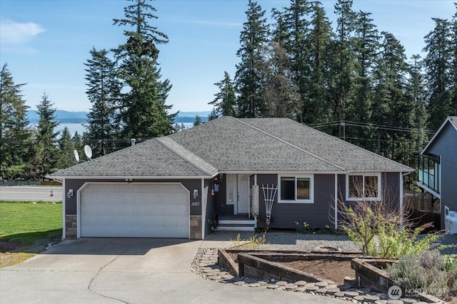 ranch-style home with driveway, a shingled roof, and a garage