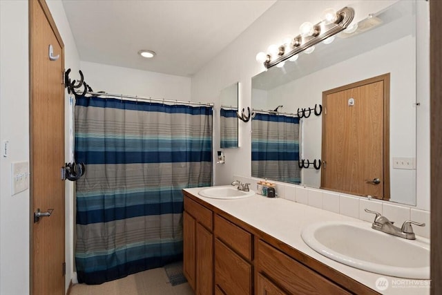 full bathroom with double vanity, a sink, and a shower with curtain