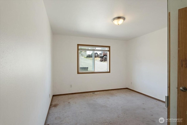 unfurnished room featuring baseboards and carpet flooring