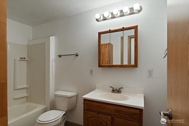 bathroom with shower / washtub combination, toilet, and vanity