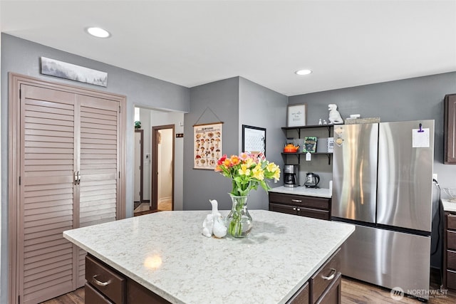 13328 67th Ave E, Puyallup, WA 98373 - kitchen featuring dark brown cabinets, a center island, recessed lighting, and freestanding refrigerator