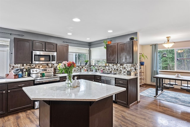 13328 67th Ave E, Puyallup, WA 98373 - kitchen featuring a sink, backsplash, appliances with stainless steel finishes, and dark brown cabinets