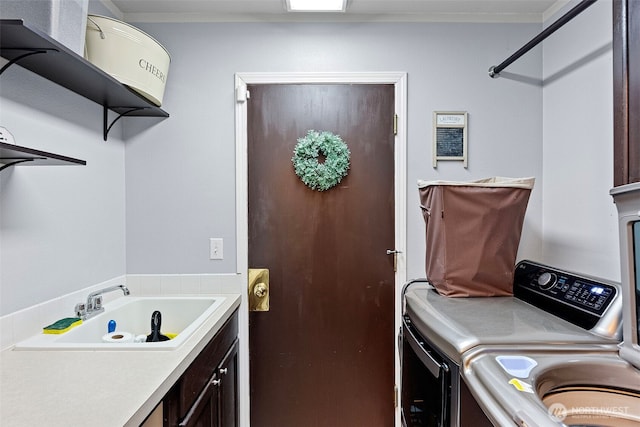 13328 67th Ave E, Puyallup, WA 98373 - laundry room featuring washing machine and clothes dryer, cabinet space, and a sink