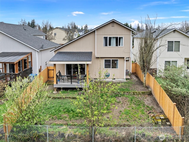 13328 67th Ave E, Puyallup, WA 98373 - back of property with a shingled roof, a fenced backyard, and a wooden deck