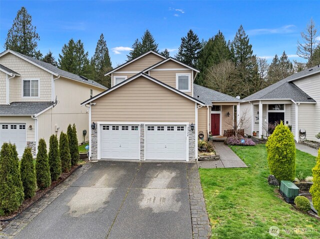 13328 67th Ave E, Puyallup, WA 98373 - view of front of house with stone siding, aphalt driveway, and a front yard