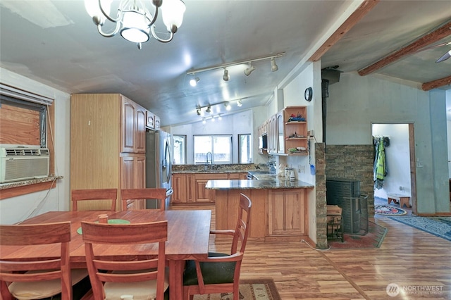 dining area featuring vaulted ceiling with beams, cooling unit, an inviting chandelier, and light wood finished floors