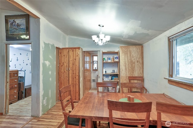 dining area featuring a chandelier and light wood finished floors