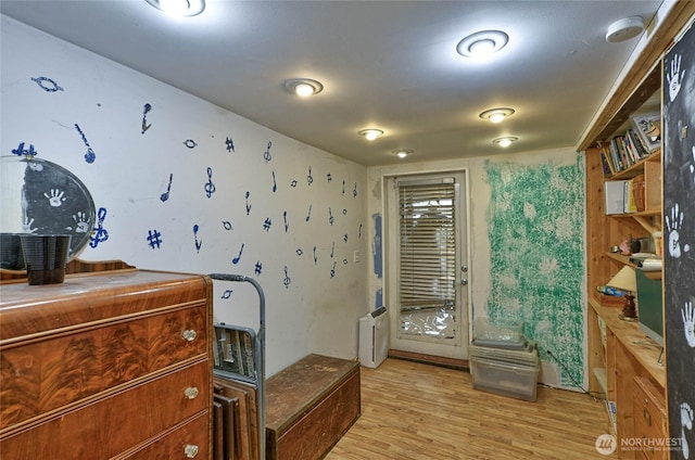 interior space featuring light wood-type flooring and radiator heating unit
