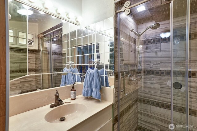 bathroom featuring a shower stall and vanity