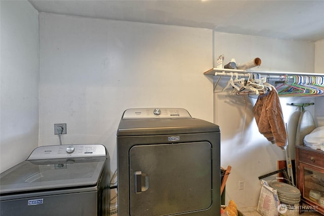 laundry area with washing machine and clothes dryer and laundry area