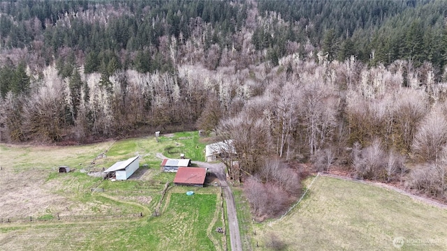 drone / aerial view featuring a rural view and a wooded view