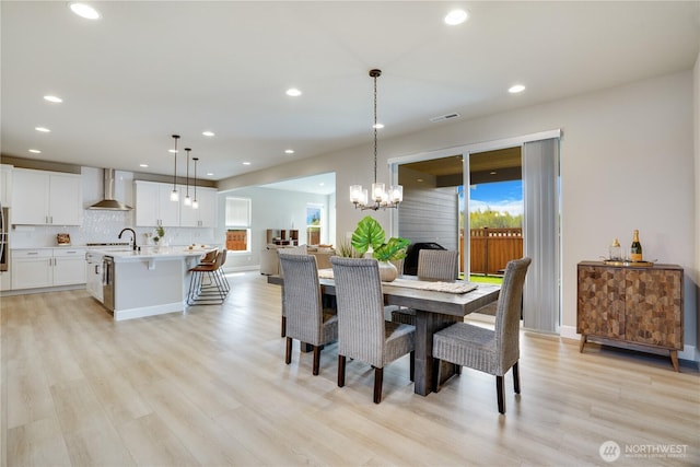 dining room featuring recessed lighting, light wood-style floors, visible vents, and a chandelier