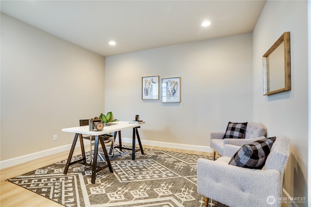 office space with baseboards, light wood finished floors, and recessed lighting