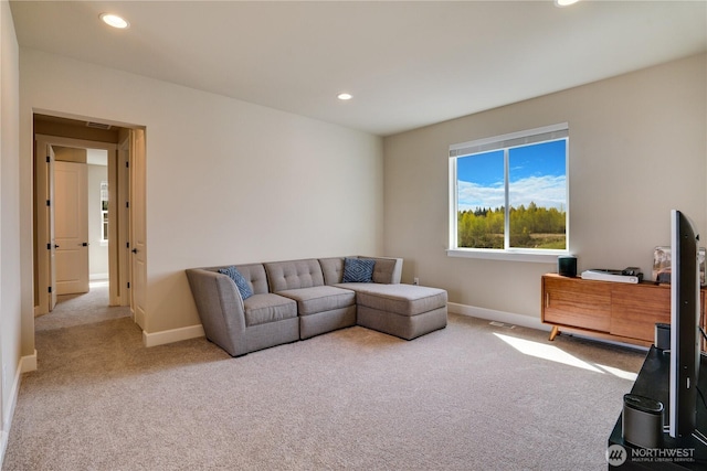 carpeted living area featuring baseboards and recessed lighting